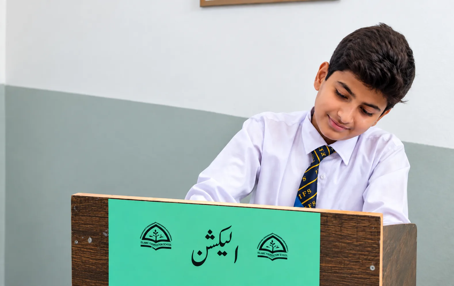 Student casting his vote at the school election
